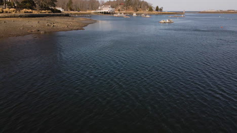 Low-drone-aerial-footage-of-small-fishing-boats-at-Cohasset-Harbor,-MA