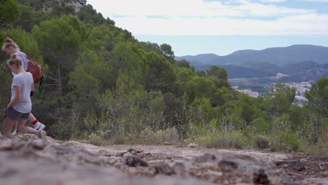 Two-young-girls-hiking-in-forests-of-Alcoi-mountains,Valencia,Spain