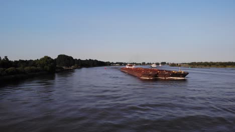 Aerial-View-Forward-Bow-Of-Veerhaven-Pusher-Boat-Transporting-Three-Barges-Along-Oude-Mass