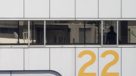 Silhouette-Of-Passengers-Getting-Off-The-Plane-At-The-Haneda-Airport-In-Tokyo,-Japan-Seen-Through-Airplane-Windows