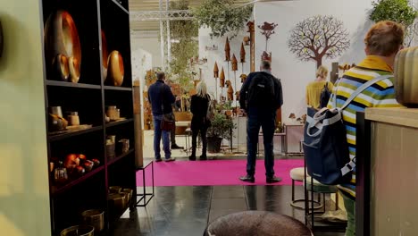 Static-shot-of-female-and-male-people-with-face-mask-shopping-inside-decoration-exhibition---Germany,Munich