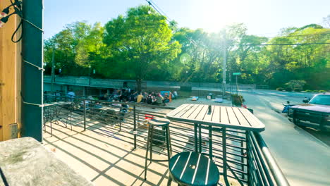 TIME-LAPSE---People-eating-outside-next-to-a-road-in-Siloam-Springs,-Arkansas