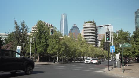 Pan-right-of-Peru-Square-and-Isidora-Goyenechea-Avenue-traffic-in-modern-Sanhattan-area,-Santiago,-Chile