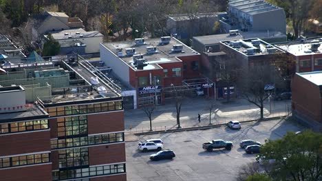 Busy-road-in-city-downtown-neighbourhood-in-district-with-shops-on-street---Sackville-and-Queen-Street-East-in-Toronto,-Ontario,-Canada