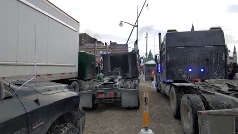 Freedom-convoy-truckers-protest-in-Ottawa,-Ontario,-Canada---slow-moving-dolly-shot