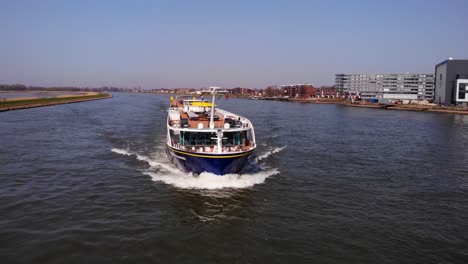 Aerial-Flying-Over-River-Noord-With-Spirit-Of-The-Danube-Approaching-On-Clear-Day-In-Alblasserdam