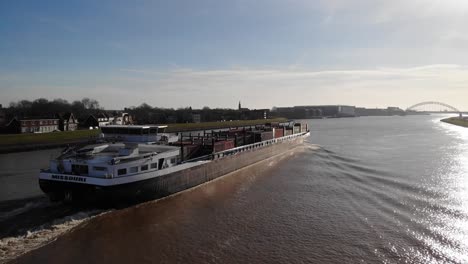 Aerial-Starboard-View-Beside-Missouri-Cargo-Ship-Heading-Towards-Brug-Over-De-Noord-In-Background