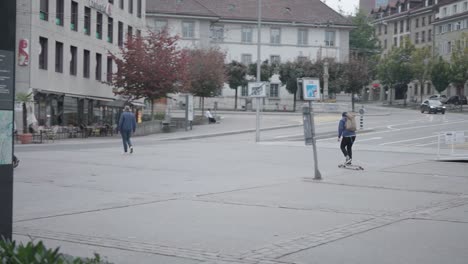 View-of-a-young-skateboarder-riding-on-cemented-surface-on-a-cold-winter-day