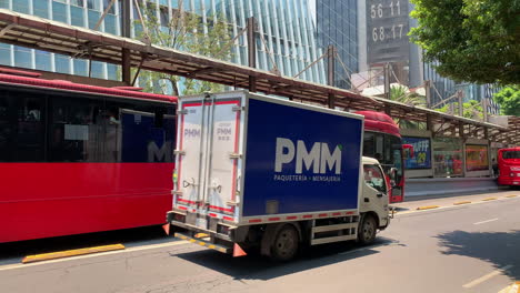 Long-Red-Articulated-Red-Mexico-City-Metrobus-Coming-To-A-Stop-On-Dedicated-Bus-Lane-In-Mexico-City