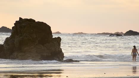 Several-tourists-at-Playitas-beach-near-Manuel-Antonio,-Costa-Rica-during-sunset