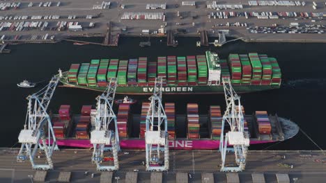 Logistics-And-Transportation-Of-Container-Cargo-Ship-With-Working-Crane-At-Husky-Terminal,-Tacoma,-Washington---aerial-drone-shot