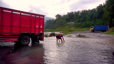 Primer-Plano-De-Un-Trabajador-Recogiendo-Arena-Del-Río-Y-Poniéndola-En-Un-Camión-En-Bego-Pendem-En-Indonesia