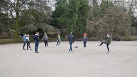 Friends-playing-football-tennis-for-fun-outdoors-in-the-park---Vorst,-Belgium