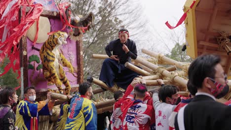 Japanese-Man-Standing-on-Top-of-Year-of-Tiger-Floats-at-Sagicho-Festival