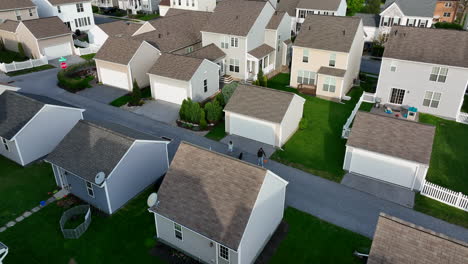 Family-dad-and-children-shoot-basketball-at-hoop-in-American-residential-community