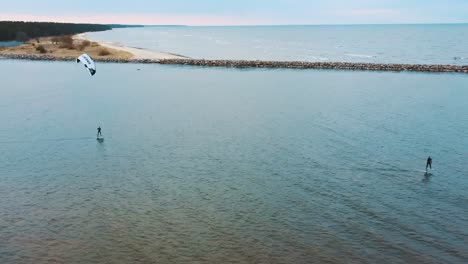 Engure,-Latvia,-23-May-2022:-Aerial-Drone-View-of-a-Corekites-Kitesurfers-Hydrofoiling-in-Engure-Port-at-in-Baltic-Sea