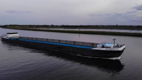 Unloaded-Semper-Fi-Cargo-Ship-Sailing-On-Waterway-During-Sunset-In-Barendrecht,-South-Holland,-Netherlands