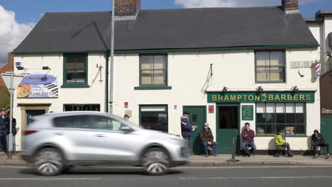 A-line-of-people-queuing-and-waiting-for-a-barbers-after-hairdressers-are-allowed-to-open-after-lockdown-in-UK