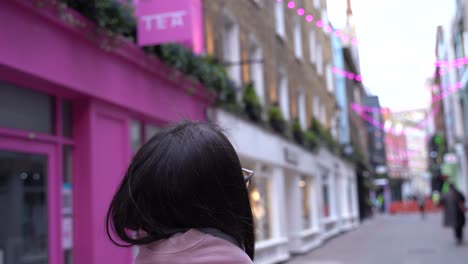 Following-a-beautiful-young-woman-looking-all-around-her,-close-up-spinning-shot