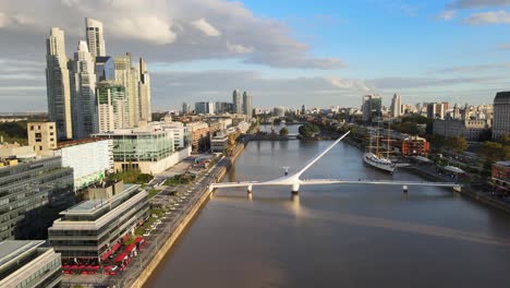 Forward-aerial-of-Puente-de-la-Mujer-and-Puerto-Madero,-Buenos-Aires