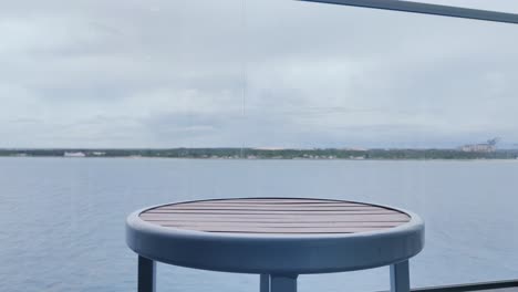 Heineken-beer-bottle-on-table-with-beautiful-Caribbean-sea-in-the-background-Video-background-in-4K