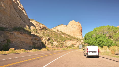 Traffic-By-The-Highway-Passing-By-Steep-Sandstone-Canyons-At-Capitol-Reef-National-Park,-Utah,-United-States