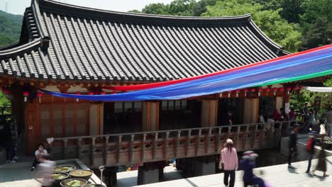 Korean-People-In-Masks-entering-Cheonggyesa-Temple-on-Buddha's-birthday,-South-Korea