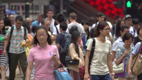 Many-Hong-Kong-working-people-of-different-ages-walking-with-bags-or-backpacks-hanging-on-the-street