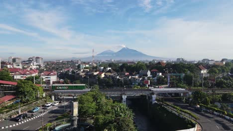 Der-Zug,-Der-Die-Stadtbrücke-überquert-Und-Die-Wunderschöne-Aussicht-Auf-Den-Berg-Merapi-Genießt