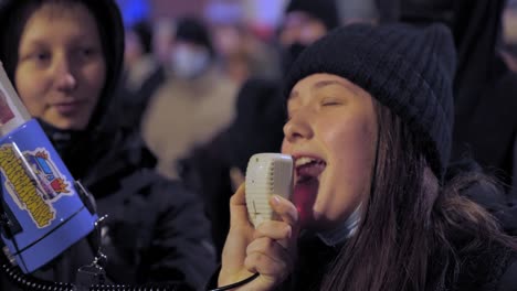 2022-Russia-invasion-of-Ukraine---protester-with-a-megaphone-at-an-anti-war-demonstration-in-Warsaw-on-the-very-first-day-of-the-war