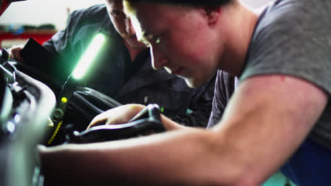 Mechanic-teaching-young-male-student-about-car-engines-at-a-vocational-high-school-in-Slovakia