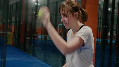 Young-Girl-Bouncing-Padel-Ball-and-Serves---Handheld-Medium-Close-Up