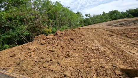 POV-while-operating-a-skid-steer-loader-to-smooth-the-side-wall-a-large-pond-at-a-land-development-site