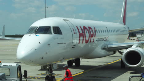 Embraer-190-Air-France-Hop-jet-parked-at-gate,-being-prepared-for-pushback,-takeoff