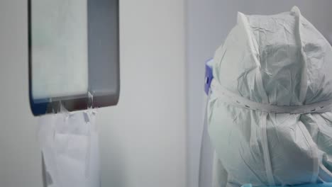 Asian-Woman-Wear-PPE-Look-Inside-Operating-Room-Window,-Close-Up