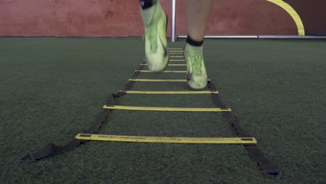 A-football-player-on-a-speed-and-agility-training-ladder-rings-in-the-field