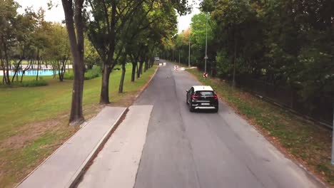 Aerial-view-of-a-black-and-white-Renault-Captur-car-speeding-on-a-road