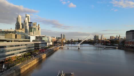 Aerial-dolly-out-shot-revealing-two-old-port-cranes-in-Puerto-Madero-waterfront,-Buenos-Aires