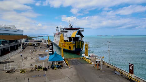 Sea-ferry-docked-in-Merak-port-on-Java-Indonesia,-aerial-orbiting-shot