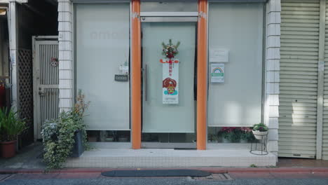 People-And-Vehicles-On-The-Street-Passing-By-A-Store-Closed-On-New-Year's-Day-In-Tokyo-During-Covid-19-Crisis