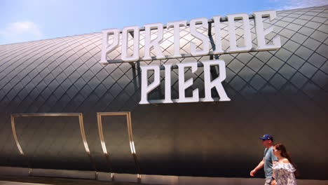 Portside-Pier-Sign-With-Passerby-In-North-Harbor-Drive,-San-Diego,-California