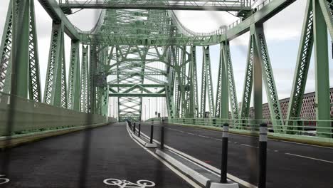 Closed-empty-unused-Runcorn-Silver-Jubilee-bridge-crossing-right-dolly-slow-through-security-fence