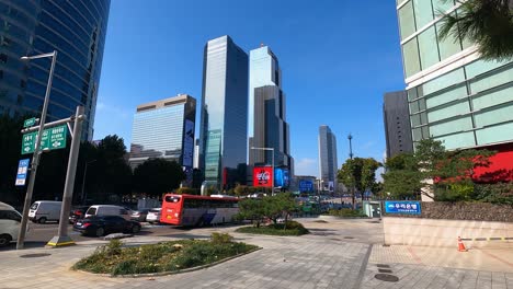 Traffic-on-Yeongdong-daero-road-and-people-walking-near-Samseong-station-Coex-World-Trade-Center-Seoul-,-South-Korea-daytime-wide-static-time-lapse