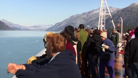 Cruising-in-Alaska-in-summer,-passengers-on-the-bow-of-the-ship