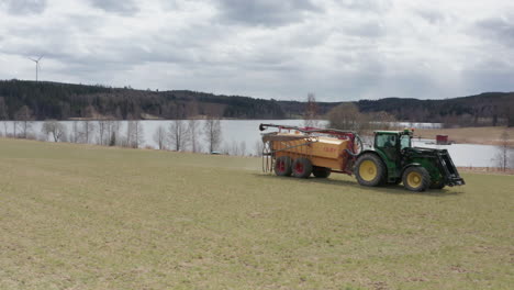 Agricultura---Tractor-Moviéndose-A-Través-De-Un-Campo,-Amplio-Seguimiento-De-Tiro-A-La-Derecha