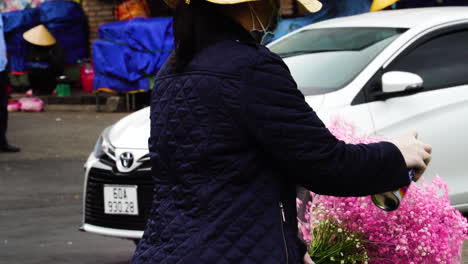 Street-seller-spray-painting-pink-on-artificial-flowers-at-Da-Lat-Vietnam