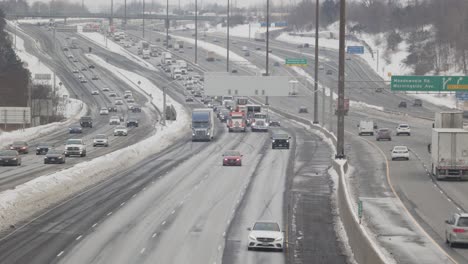 Large-Convoy-of-Transport-Trucks-heading-East-on-5-lane-highway-creating-traffic-congestion