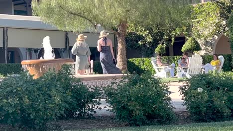 Two-Ladies-Walking-Into-Scenic-Winery-Courtyard-With-Water-Fountain-in-Temecula