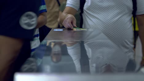 Passengers-swipe-their-metro-train-cards-at-the-turnstile-to-enter-the-subway