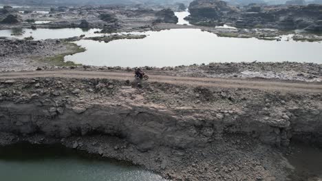 Beautiful-Indian-River-in-winter,-hilly-landscape-with-road-Aerial-view-from-drone